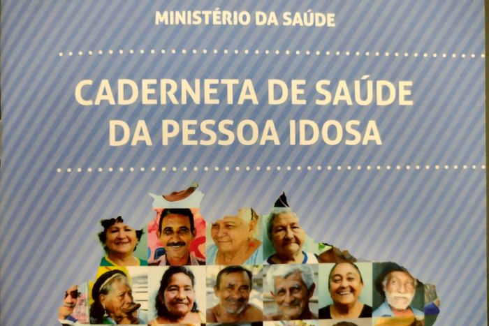 Na foto, logo no alto a inscrição Ministério da Saúde, logo abaixo vem "Caderneta de Saúde da Pessoa Idosa, e embaixo várias pequenas fotos 3x4 de pessoas idosas